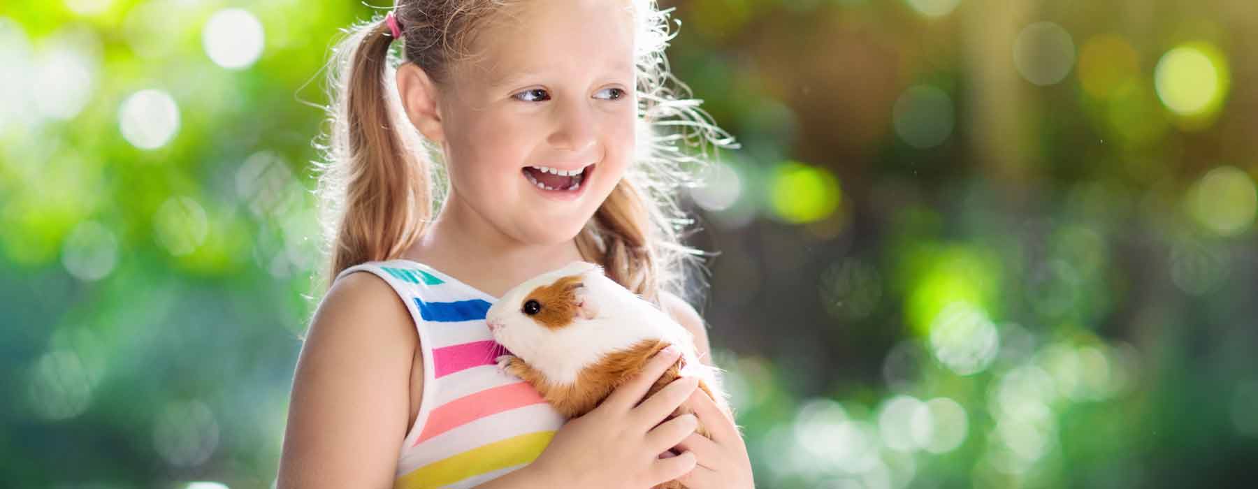 happy girl holding her guinea pig